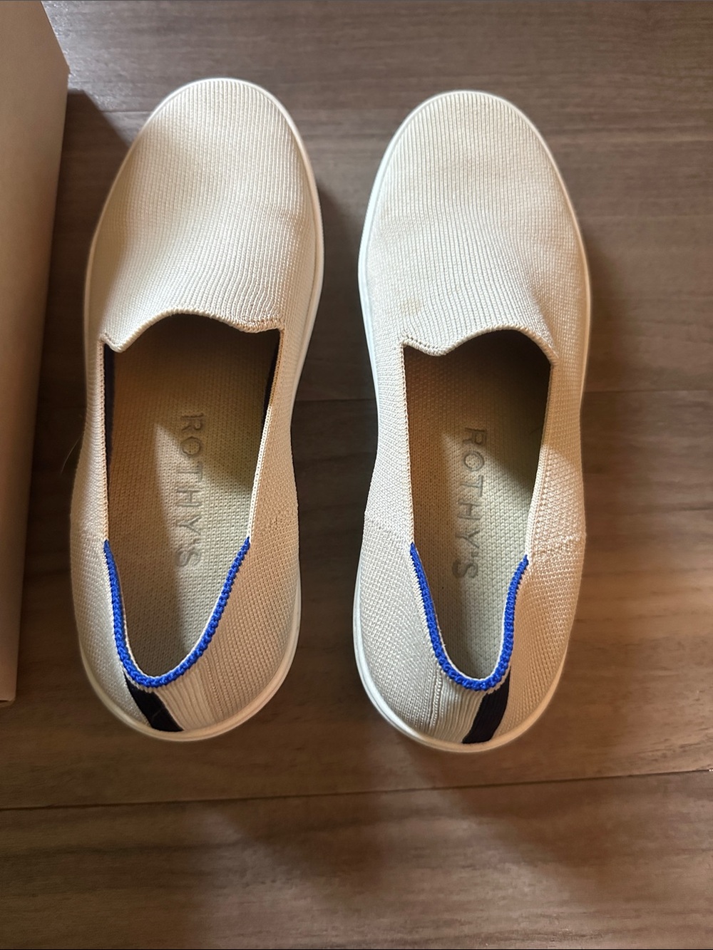 Rothy's Women's Slip-On Sneakers in Cream with Blue Trimi
